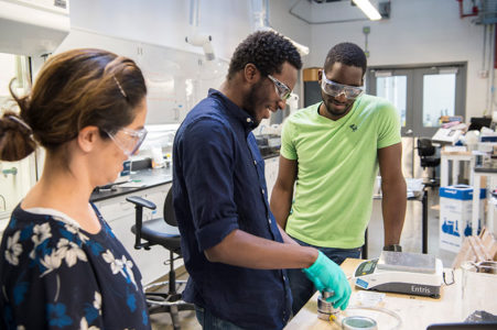 Researchers and interns at a lab bench.