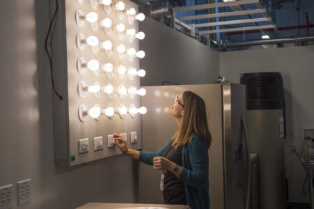 Engineer adjusts bank of dimmer lights.